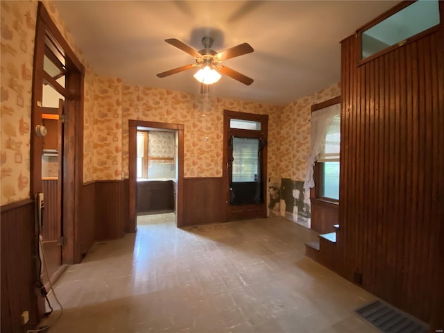 unfurnished living room with tile flooring and ceiling fan