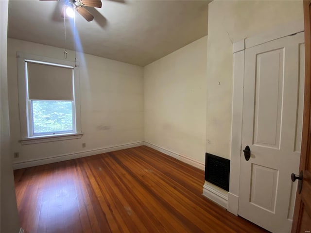 spare room with ceiling fan and dark hardwood / wood-style floors