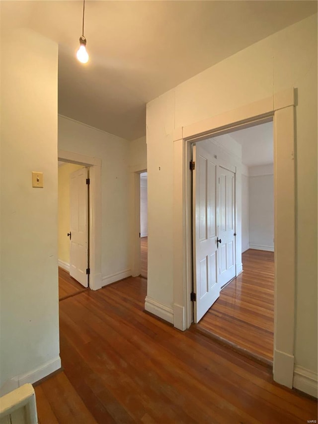 corridor featuring dark hardwood / wood-style flooring