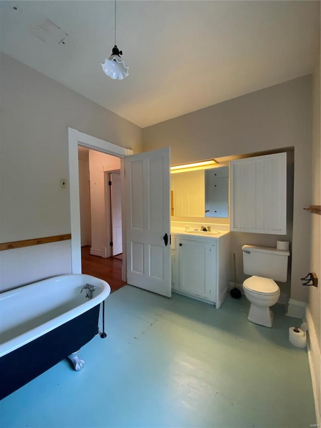 bathroom featuring hardwood / wood-style flooring, vanity, toilet, and a bath