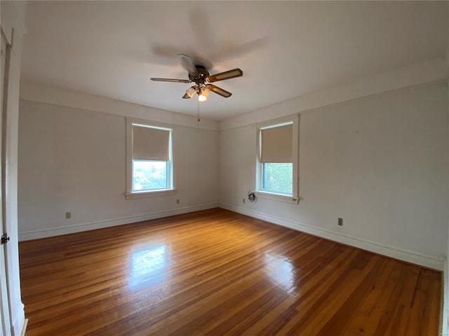 spare room with ceiling fan and hardwood / wood-style flooring