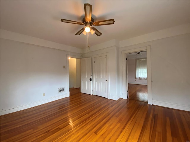 empty room featuring wood-type flooring and ceiling fan