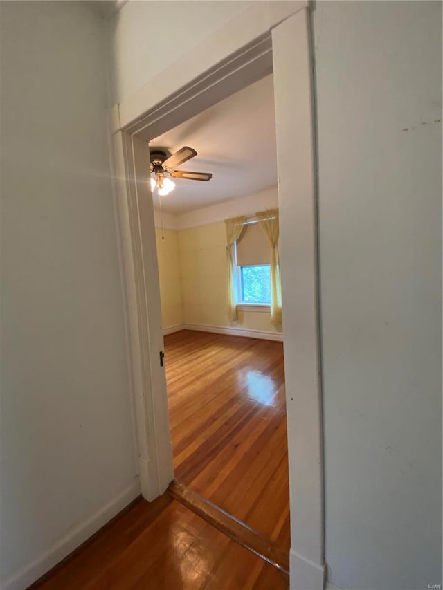 unfurnished room with hardwood / wood-style floors and ceiling fan