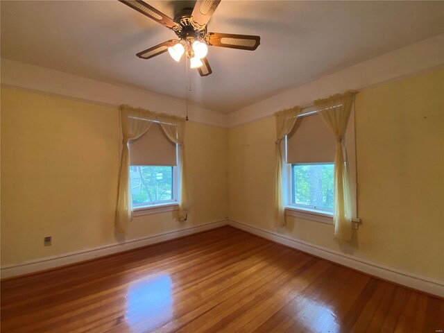 spare room featuring wood-type flooring and ceiling fan