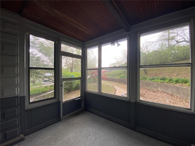 unfurnished sunroom featuring wooden ceiling