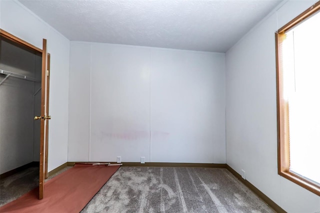 unfurnished bedroom featuring carpet floors and a textured ceiling