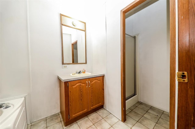 bathroom with tile flooring, walk in shower, and large vanity