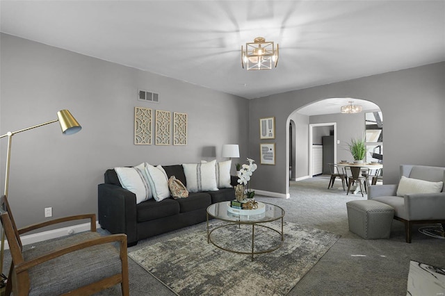 living room with carpet and a chandelier