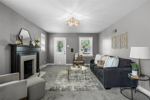 living room featuring carpet flooring and a fireplace