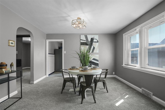 dining space featuring plenty of natural light and carpet floors