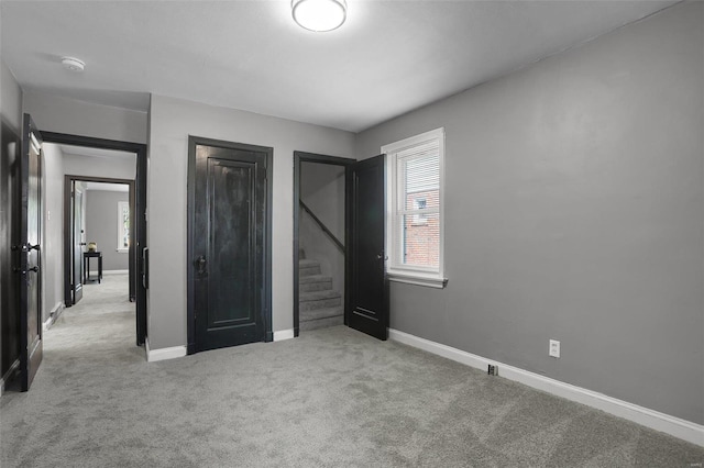 unfurnished bedroom featuring light colored carpet