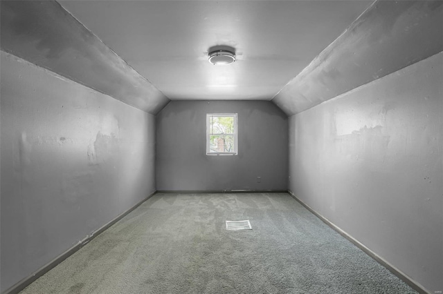 bonus room featuring light carpet and lofted ceiling