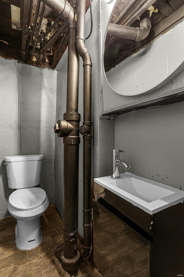 bathroom with toilet and wood-type flooring