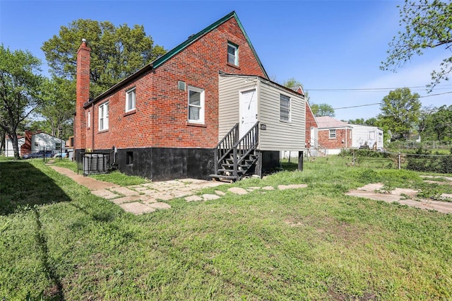 back of property featuring a lawn