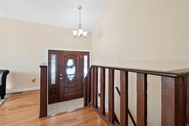 foyer featuring light hardwood / wood-style flooring and a notable chandelier