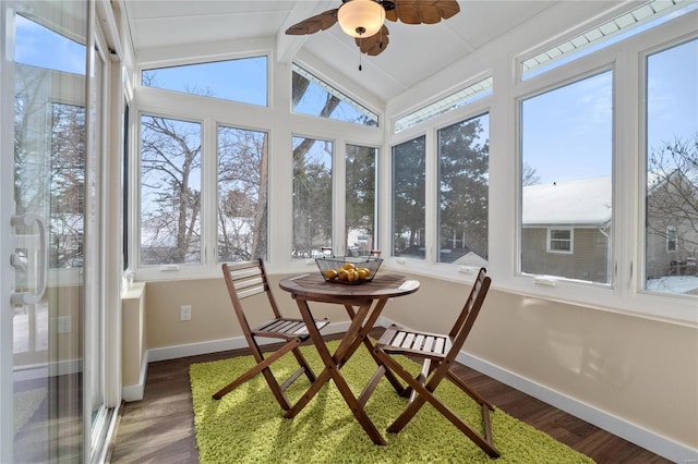 sunroom featuring ceiling fan and vaulted ceiling with beams