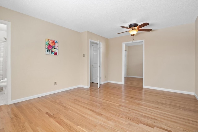 spare room featuring a textured ceiling, ceiling fan, and light hardwood / wood-style floors