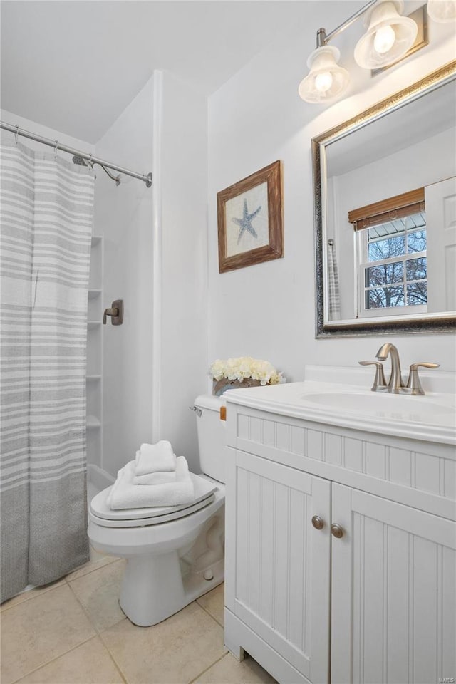 bathroom featuring toilet, a shower with curtain, tile patterned flooring, and vanity