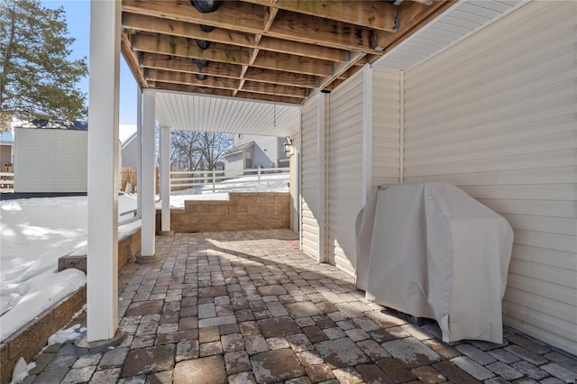 snow covered patio with grilling area