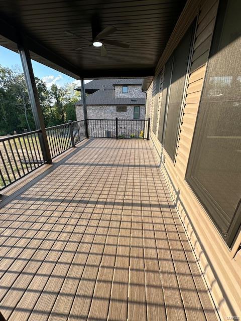 wooden terrace featuring a ceiling fan