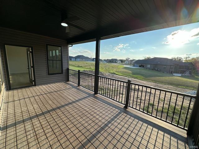 deck with a residential view and ceiling fan