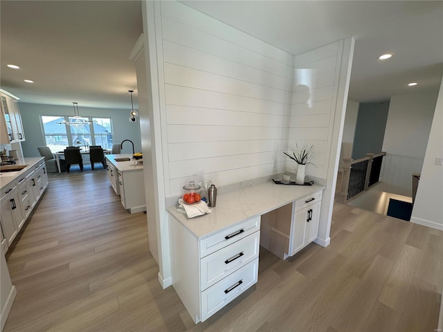 interior space featuring recessed lighting, light wood-type flooring, and a sink