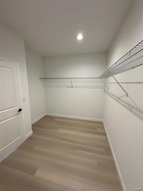 walk in closet featuring light wood-style flooring