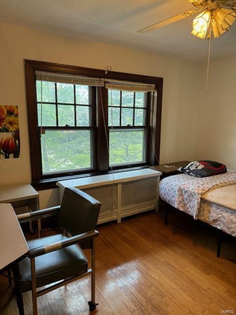 bedroom with hardwood / wood-style floors and ceiling fan