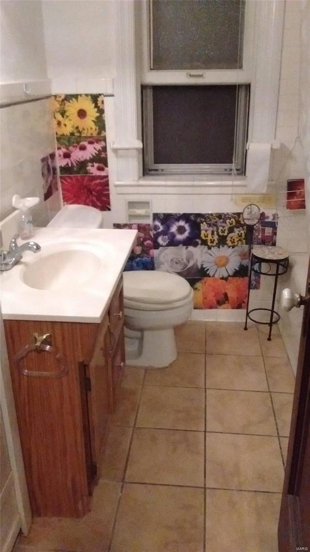 bathroom featuring vanity, tile floors, and toilet