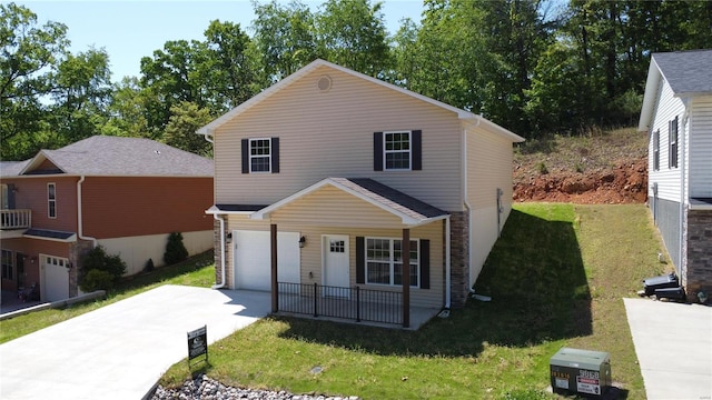 front of property featuring a garage and a front lawn