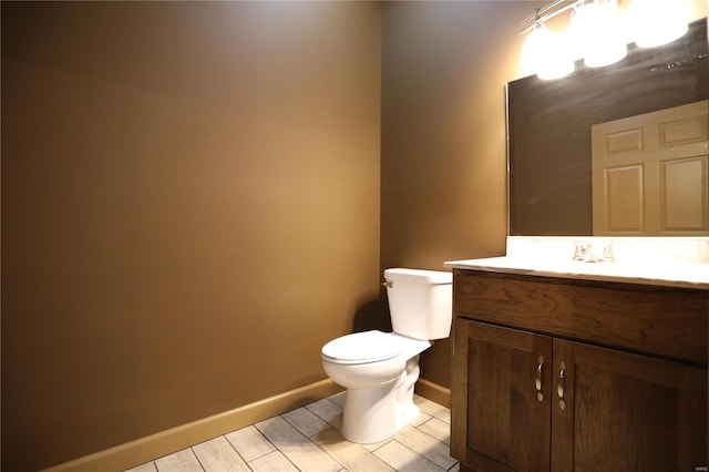 bathroom featuring wood-type flooring, vanity, and toilet