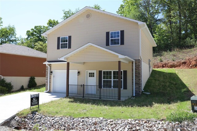 view of property with a garage and a front yard