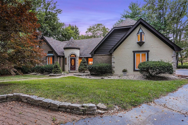 french provincial home featuring a yard