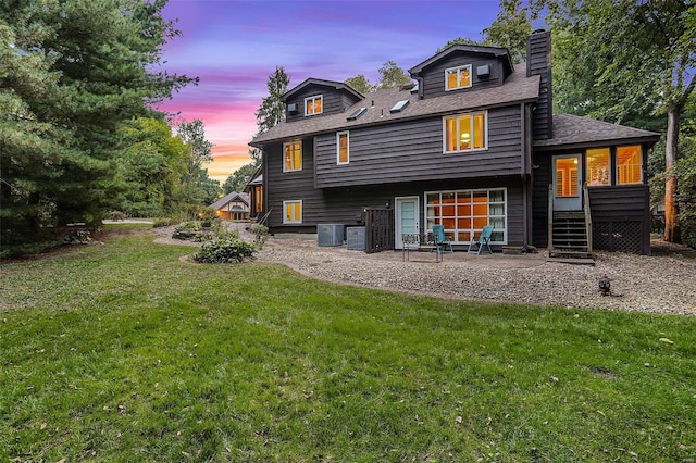 back house at dusk with a yard