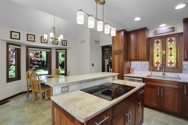 kitchen with decorative light fixtures, a center island, sink, and an inviting chandelier