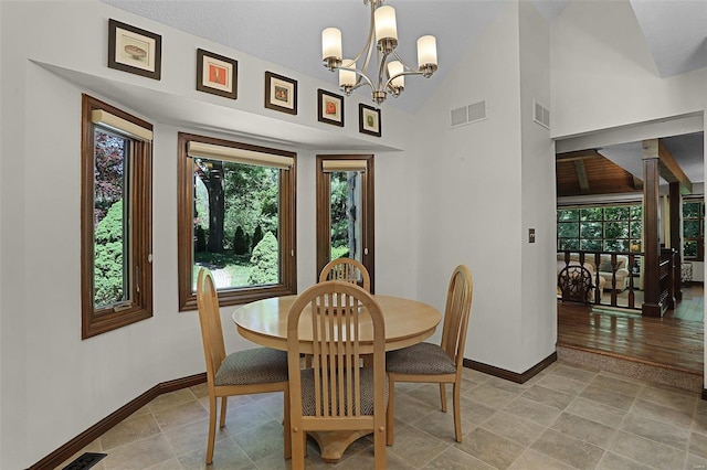 dining space featuring a wealth of natural light, a chandelier, and lofted ceiling