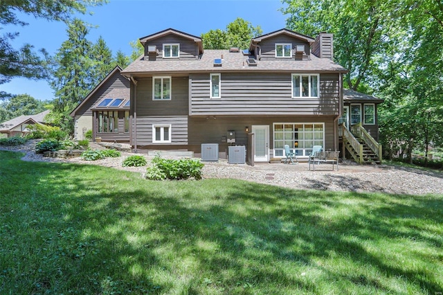 back of property featuring a yard, a patio, and central AC unit