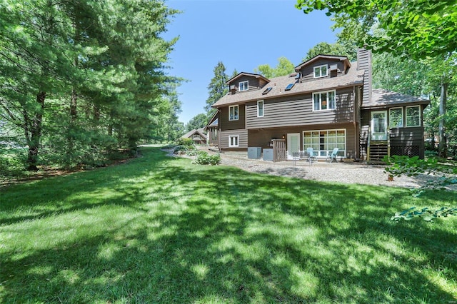 back of house with a lawn and a patio area