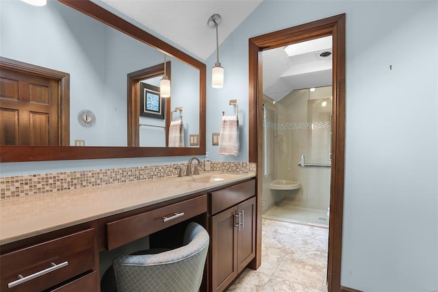 bathroom with vanity, an enclosed shower, lofted ceiling, and tasteful backsplash