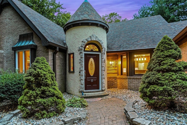 view of exterior entry at dusk