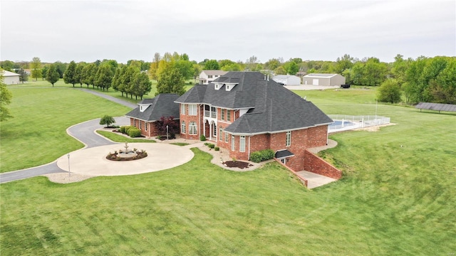 rear view of property with an outdoor fire pit and a yard