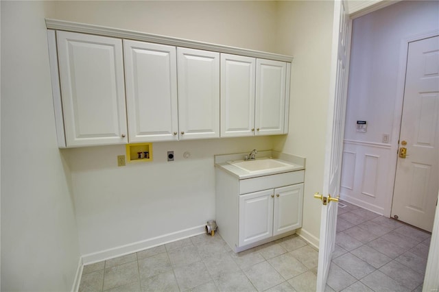 laundry room with sink, washer hookup, light tile floors, and hookup for an electric dryer