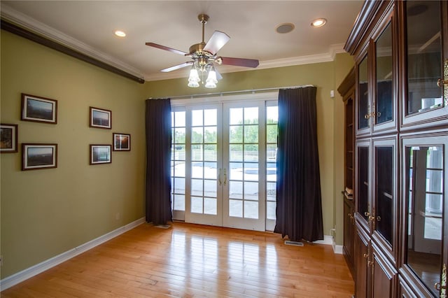 interior space featuring ceiling fan, ornamental molding, light hardwood / wood-style floors, and french doors