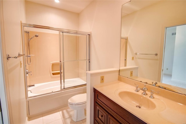 full bathroom with combined bath / shower with glass door, vanity, toilet, and tile floors