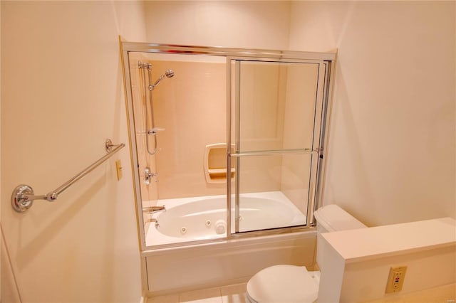 bathroom with tile flooring, toilet, and enclosed tub / shower combo