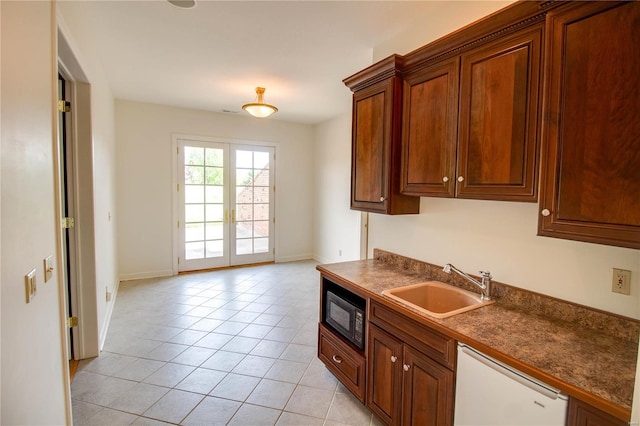 kitchen with sink, dishwasher, light tile flooring, and black microwave