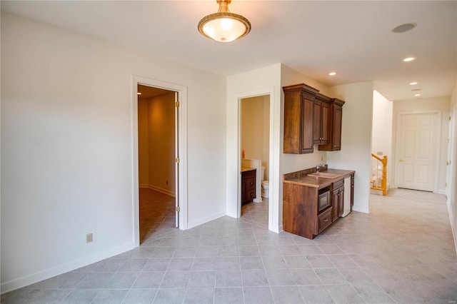 kitchen with sink and light tile floors