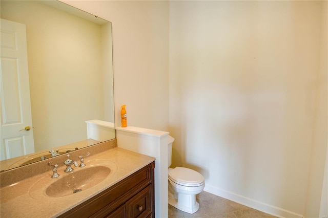 bathroom with tile flooring, vanity, and toilet