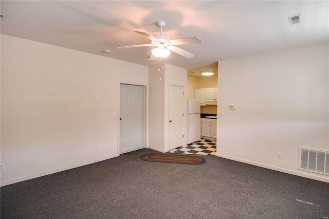 unfurnished living room with carpet and ceiling fan