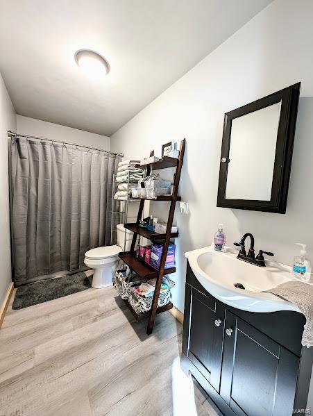 bathroom featuring hardwood / wood-style floors, vanity, and toilet